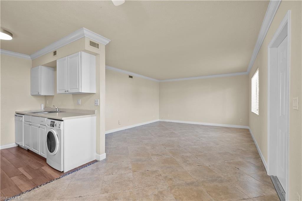 4615 Bayshore Drive, Unit E4 Naples, FL 34112 - Photo 2 of 30 a view of kitchen with granite countertop cabinets and white stove