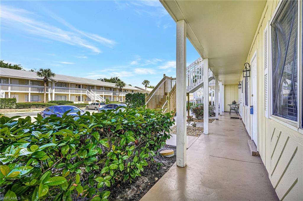 4615 Bayshore Drive, Unit E4 Naples, FL 34112 - Photo 29 of 30 a view of a garden with an outdoor seating
