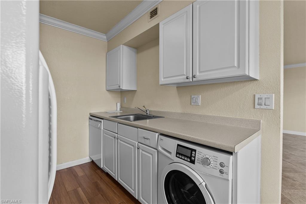 4615 Bayshore Drive, Unit E4 Naples, FL 34112 - Photo 6 of 30 a utility room with sink dryer and washer