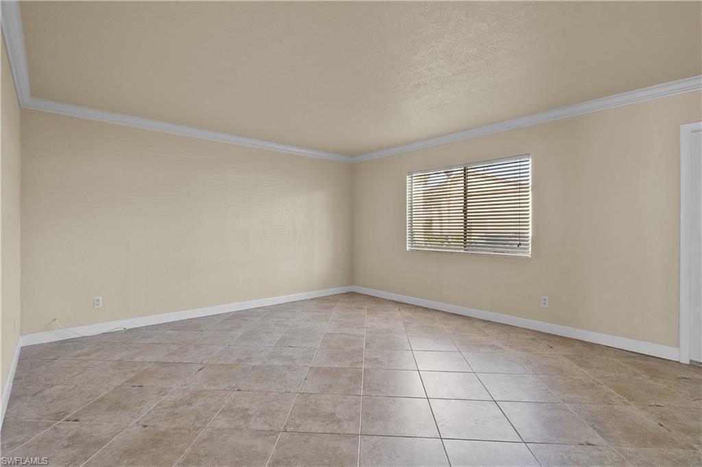 4615 Bayshore Drive, Unit E4 Naples, FL 34112 - Photo 10 of 30 an empty room with windows