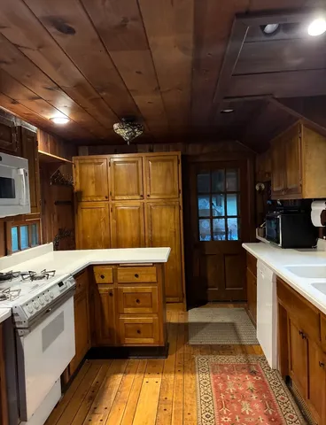a view of a dining room with furniture wooden floor and a chandelier