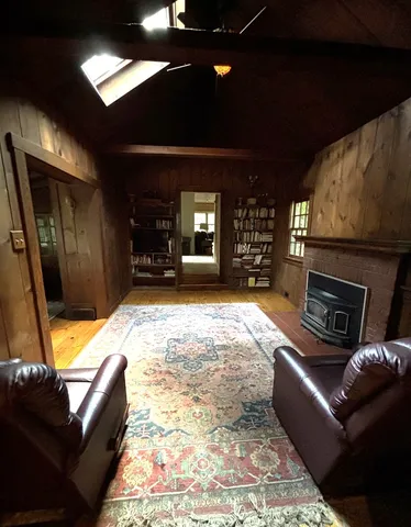 a spacious bedroom with a bed and glass window
