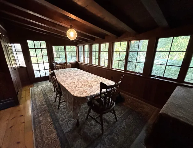 a living room with a bed furniture and a large window