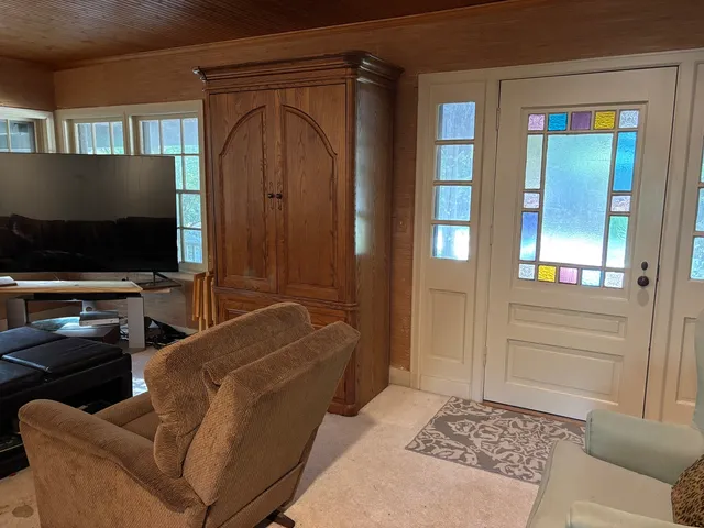 a living room with furniture and a chandelier