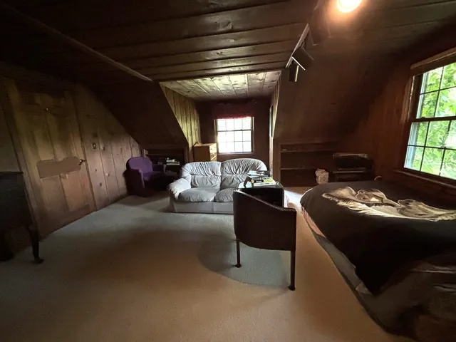 a front view of house with yard and trees around