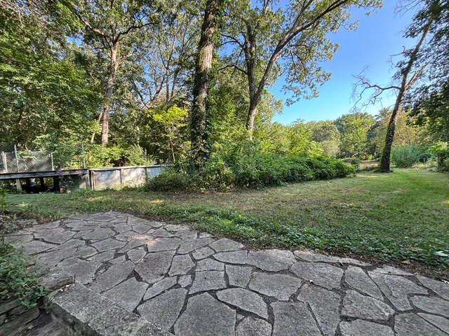 a backyard of a house with table and chairs