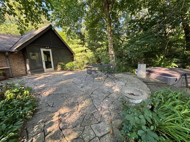 a white house with a yard and trees