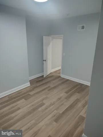 an empty room with wooden floor