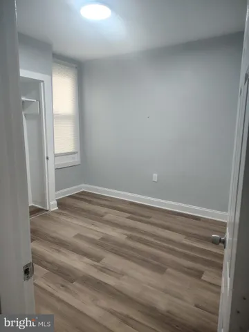 a view of wooden floor and windows in a room