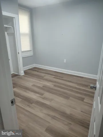 an empty room with wooden floor