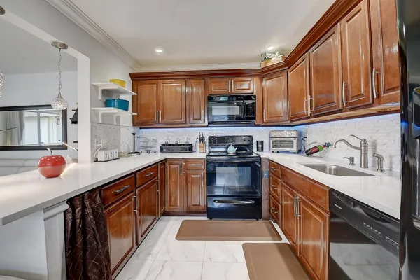 a kitchen with stainless steel appliances granite countertop a stove and a sink
