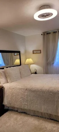 a bedroom with a bed and a mirror