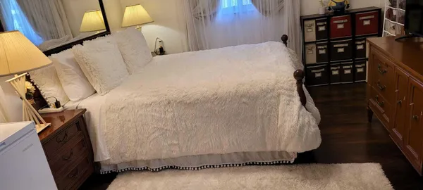 a bed sitting in a bedroom next to a window