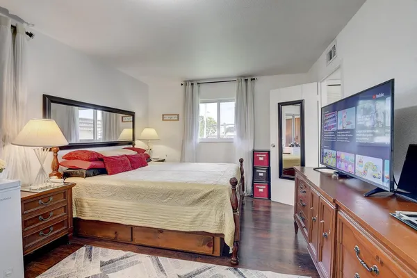 a bedroom with a bed and a dresser