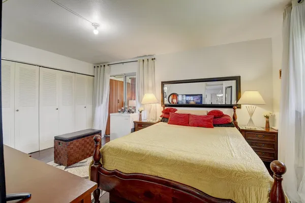 a bedroom with a bed and a closet