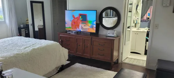 a bedroom with a bed and a dresser