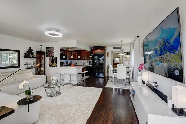a living room with lots of furniture and gym equipment