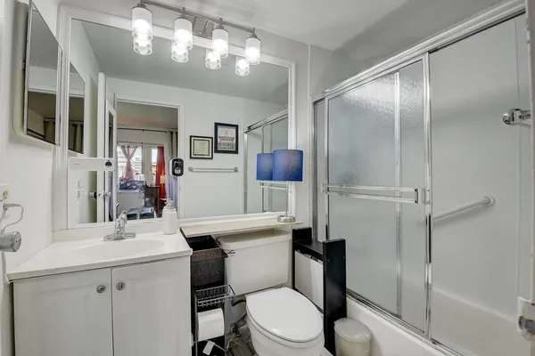 a bathroom with a sink toilet tub and shower