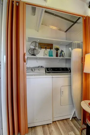 a view of walk in closet with clothes