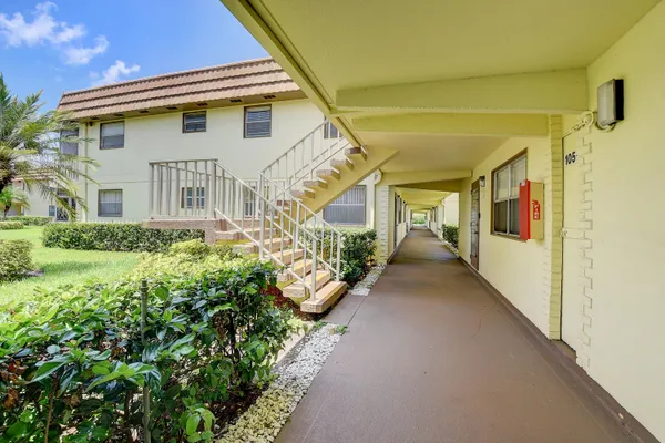 a view of a swimming pool with a patio and a yard