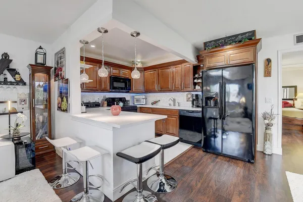 a kitchen with stainless steel appliances a refrigerator and a stove top oven