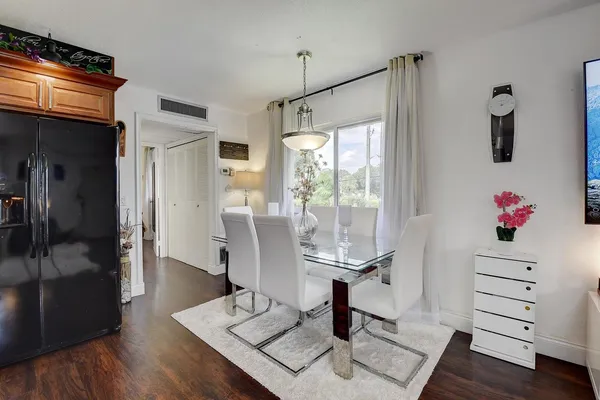 a view of a hallway with furniture and a window