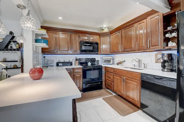 a kitchen with stainless steel appliances granite countertop a sink stove and cabinets