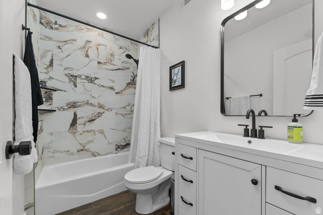 500 North 516th Street West, Unit 19 Mapleton, UT 84664 - Photo 29 of 41 Bathroom featuring a white vanity with matte black hardware, an integrated sink, a rectangular mirror, and wood-finish flooring