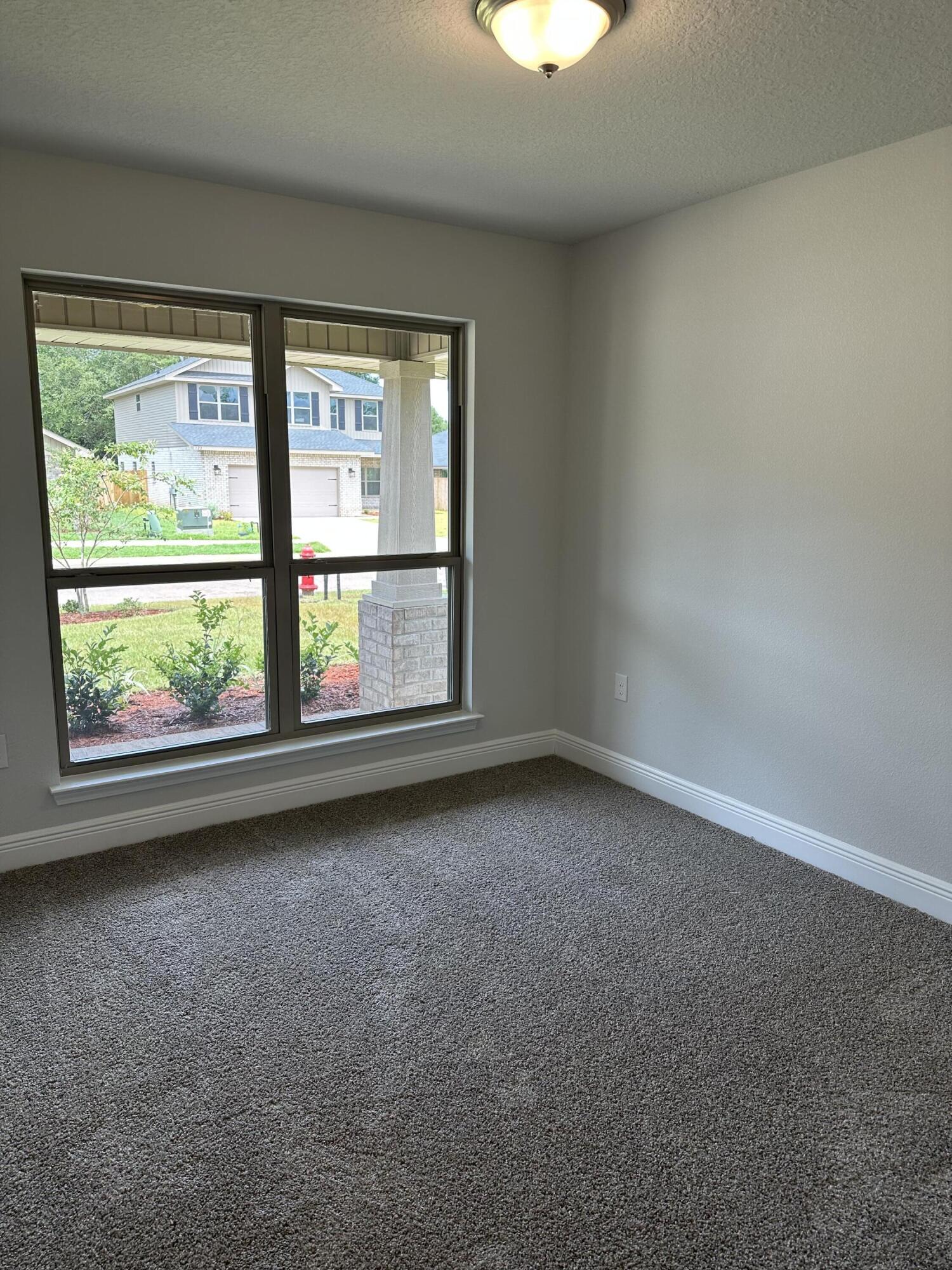 5287 Hidden Pines Circle Milton, FL 32583 - Photo 14 of 15 an empty room with windows