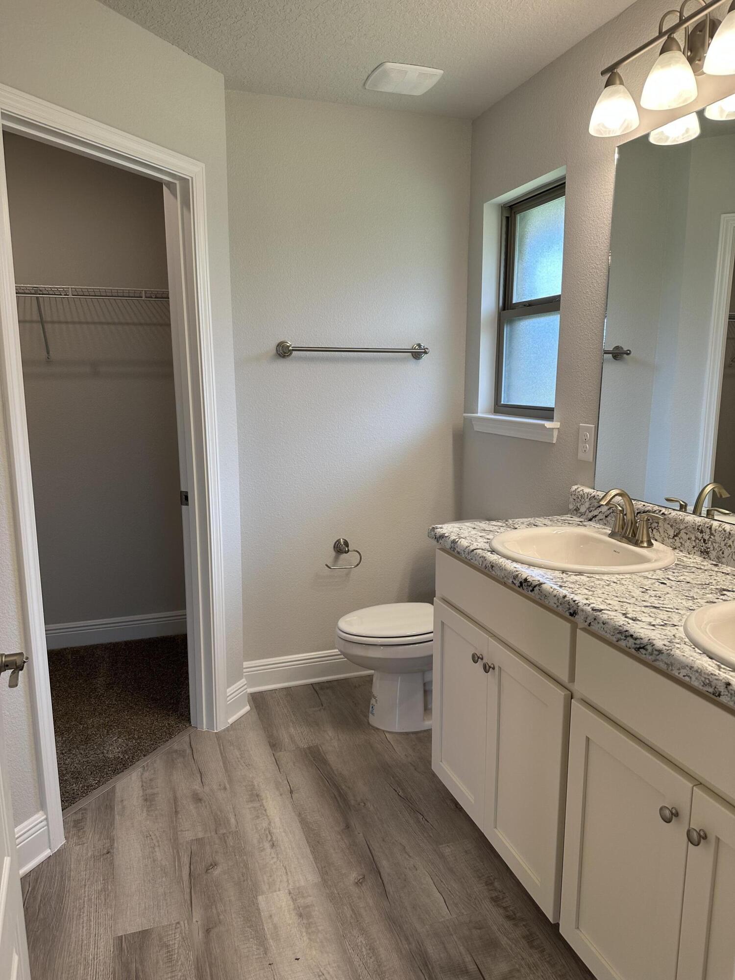 5287 Hidden Pines Circle Milton, FL 32583 - Photo 10 of 15 a bathroom with a granite countertop sink toilet and shower
