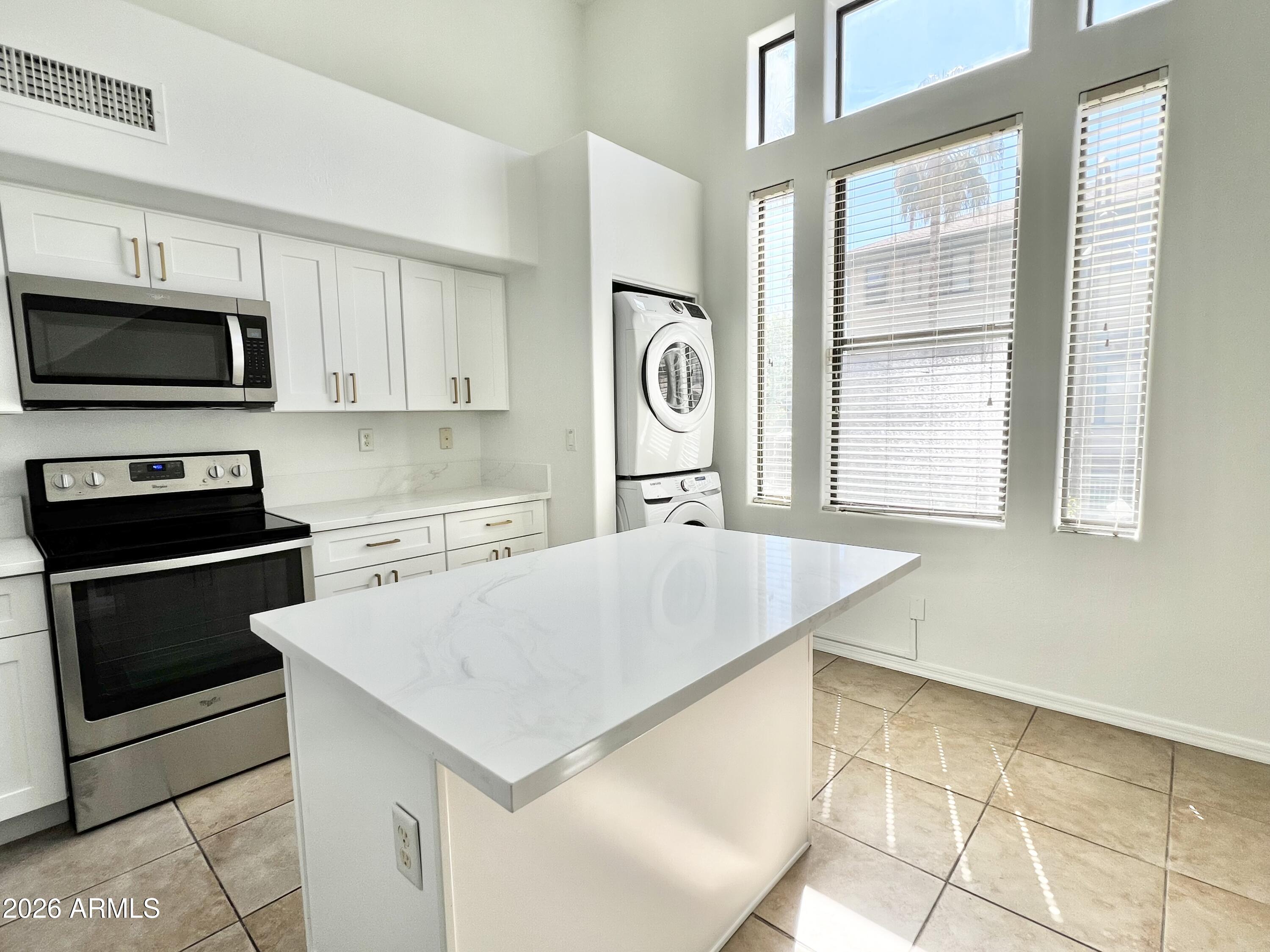 730 South Beck Avenue Tempe, AZ 85281 - Photo 11 of 29 a kitchen with granite countertop a stove a sink and a microwave