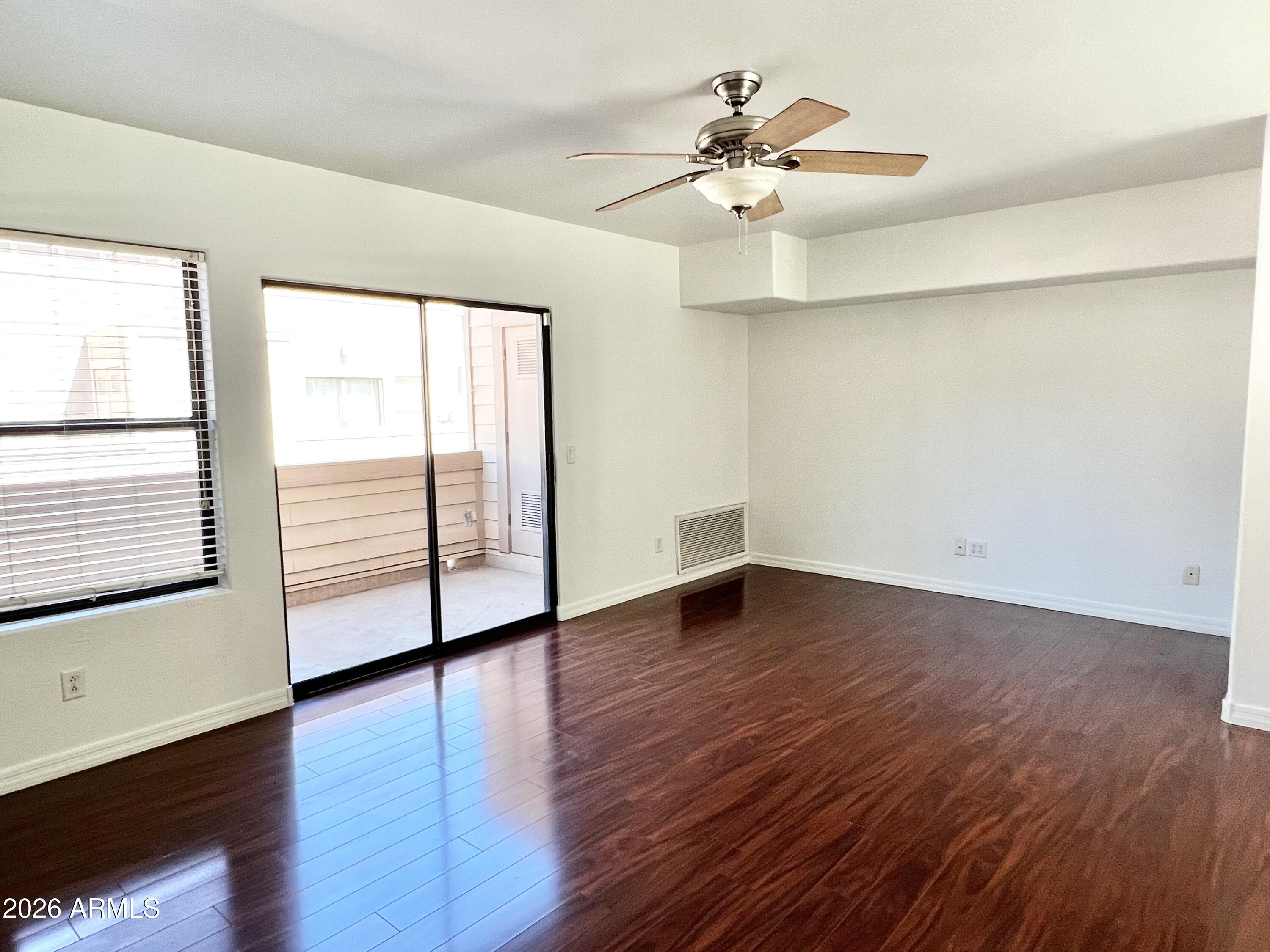 730 South Beck Avenue Tempe, AZ 85281 - Photo 17 of 29 an empty room with wooden floor chandelier fan and windows