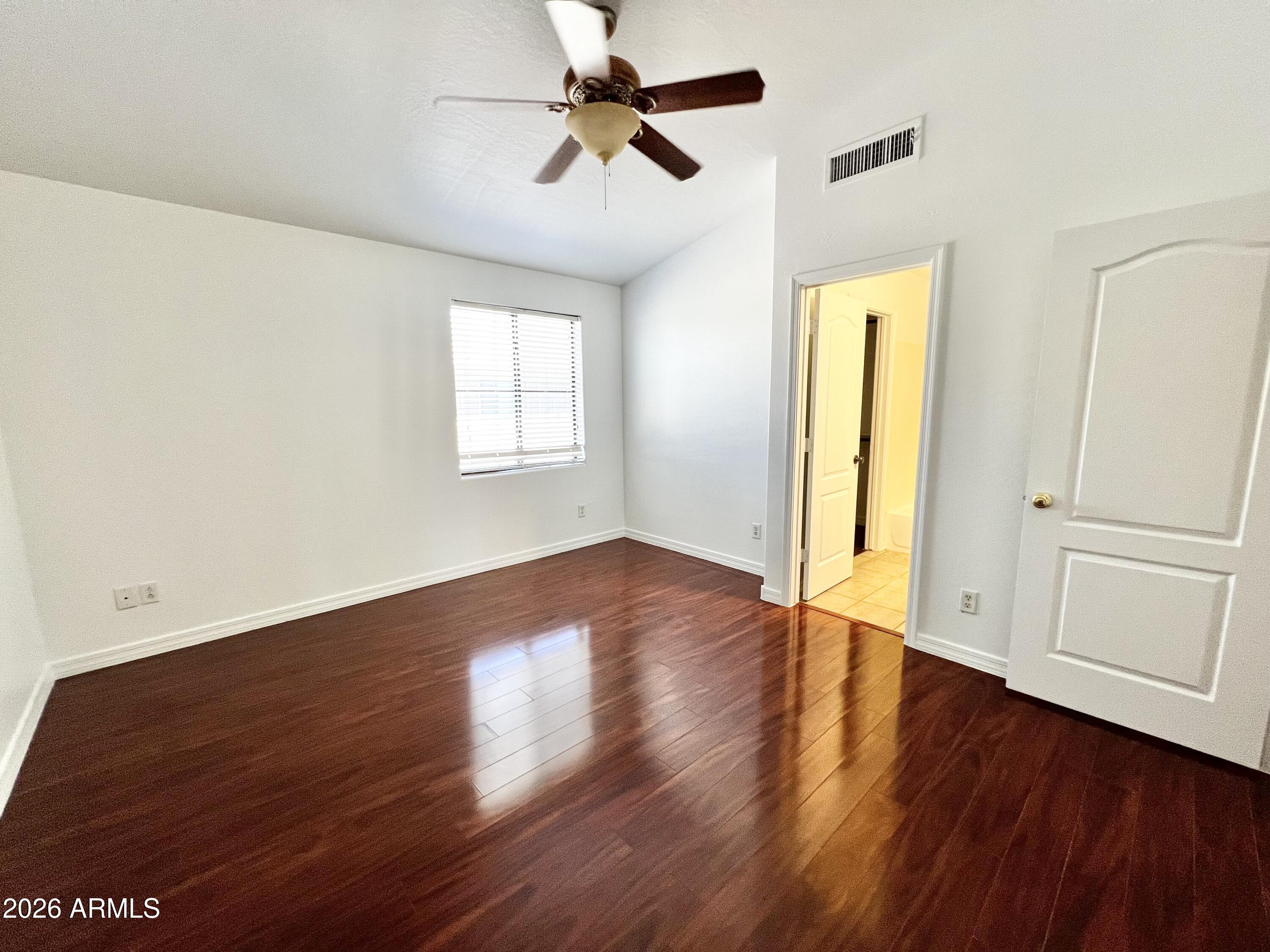730 South Beck Avenue Tempe, AZ 85281 - Photo 21 of 29 an empty room with wooden floor ceiling fan and windows