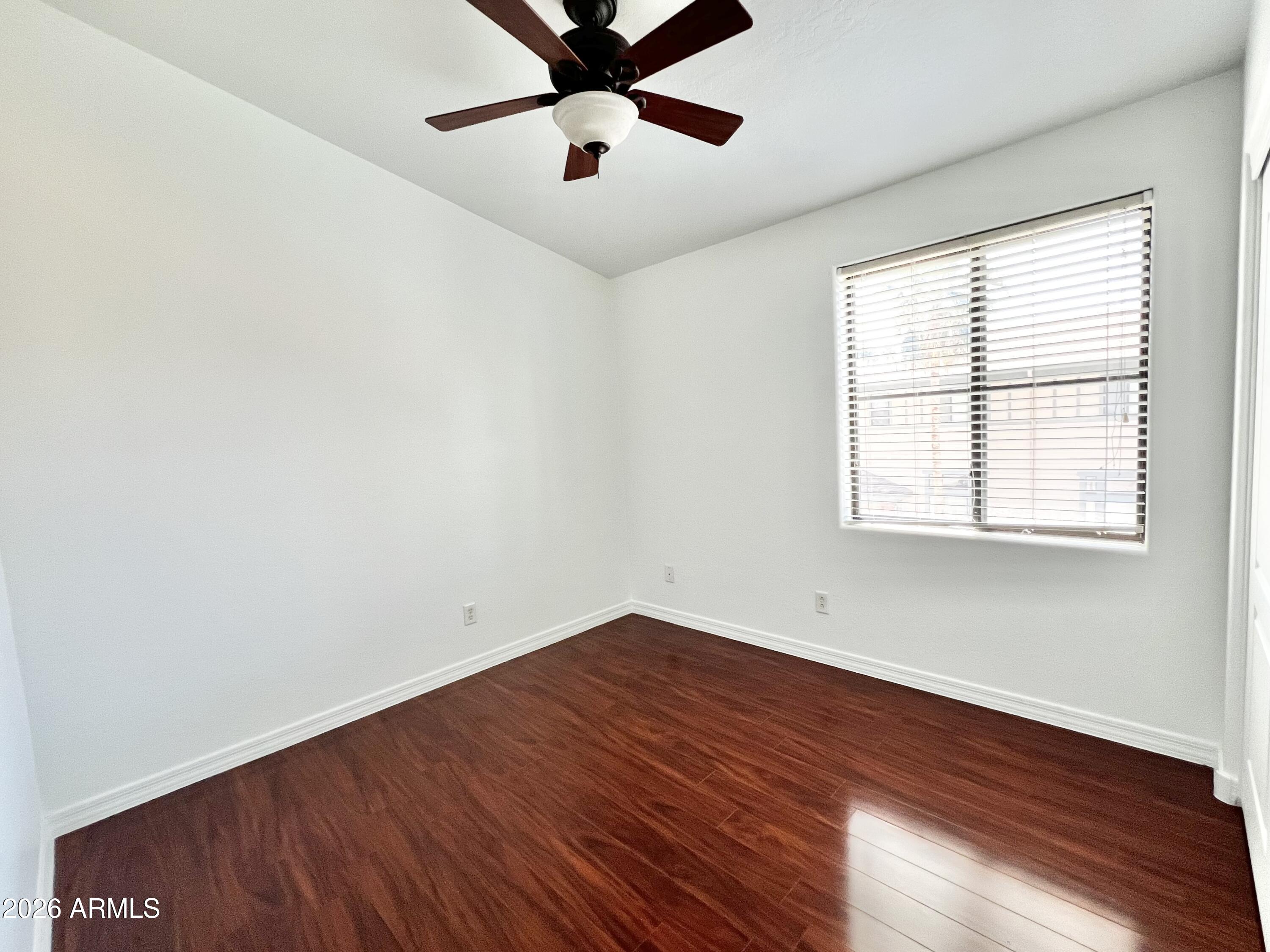 730 South Beck Avenue Tempe, AZ 85281 - Photo 22 of 29 an empty room with wooden floor fan and windows