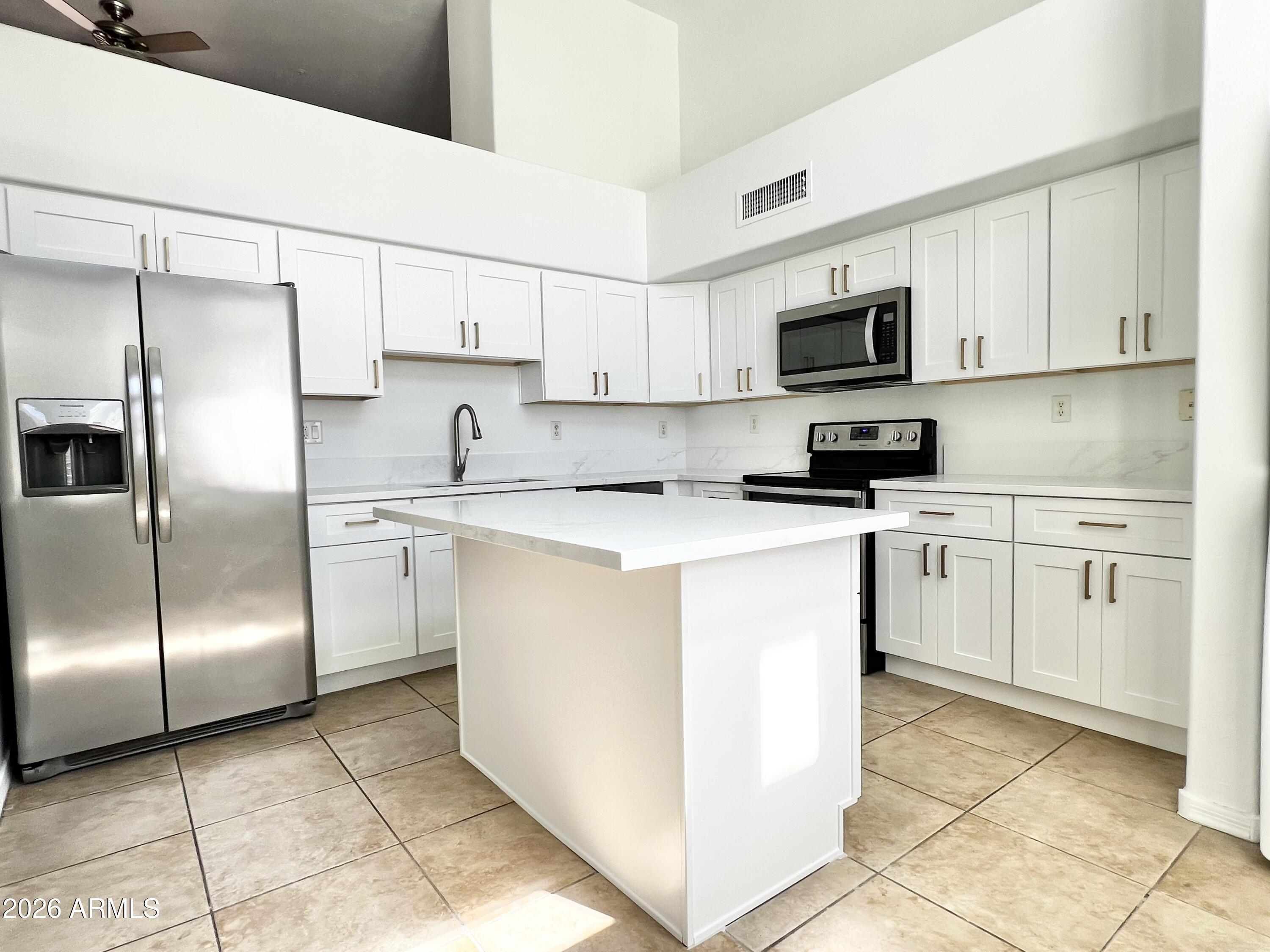 730 South Beck Avenue Tempe, AZ 85281 - Photo 6 of 29 a kitchen with white cabinets stainless steel appliances