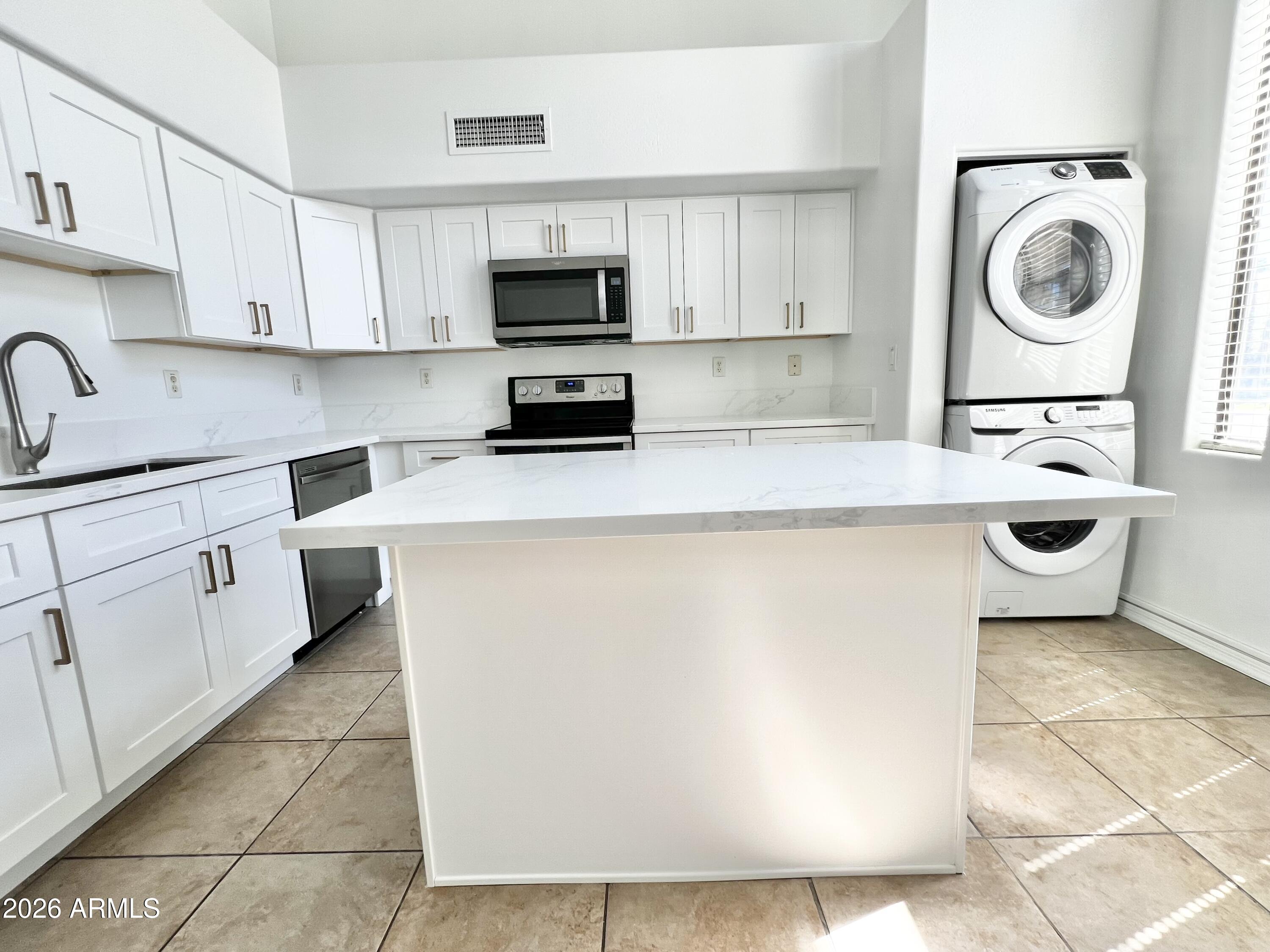 730 South Beck Avenue Tempe, AZ 85281 - Photo 7 of 29 a kitchen with a sink a stove top oven and white cabinets