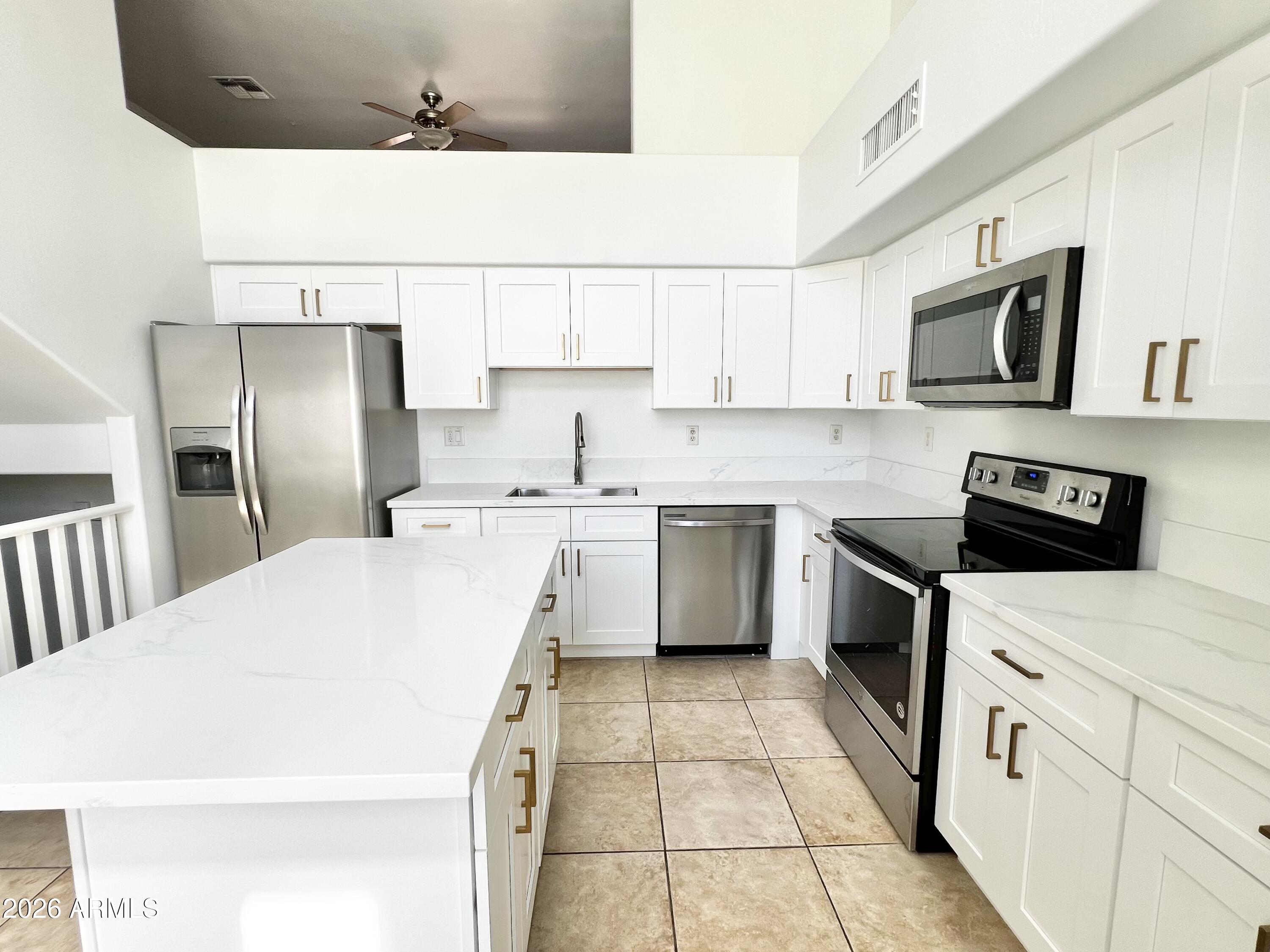 730 South Beck Avenue Tempe, AZ 85281 - Photo 8 of 29 a kitchen with stainless steel appliances granite countertop a refrigerator sink stove microwave and cabinets