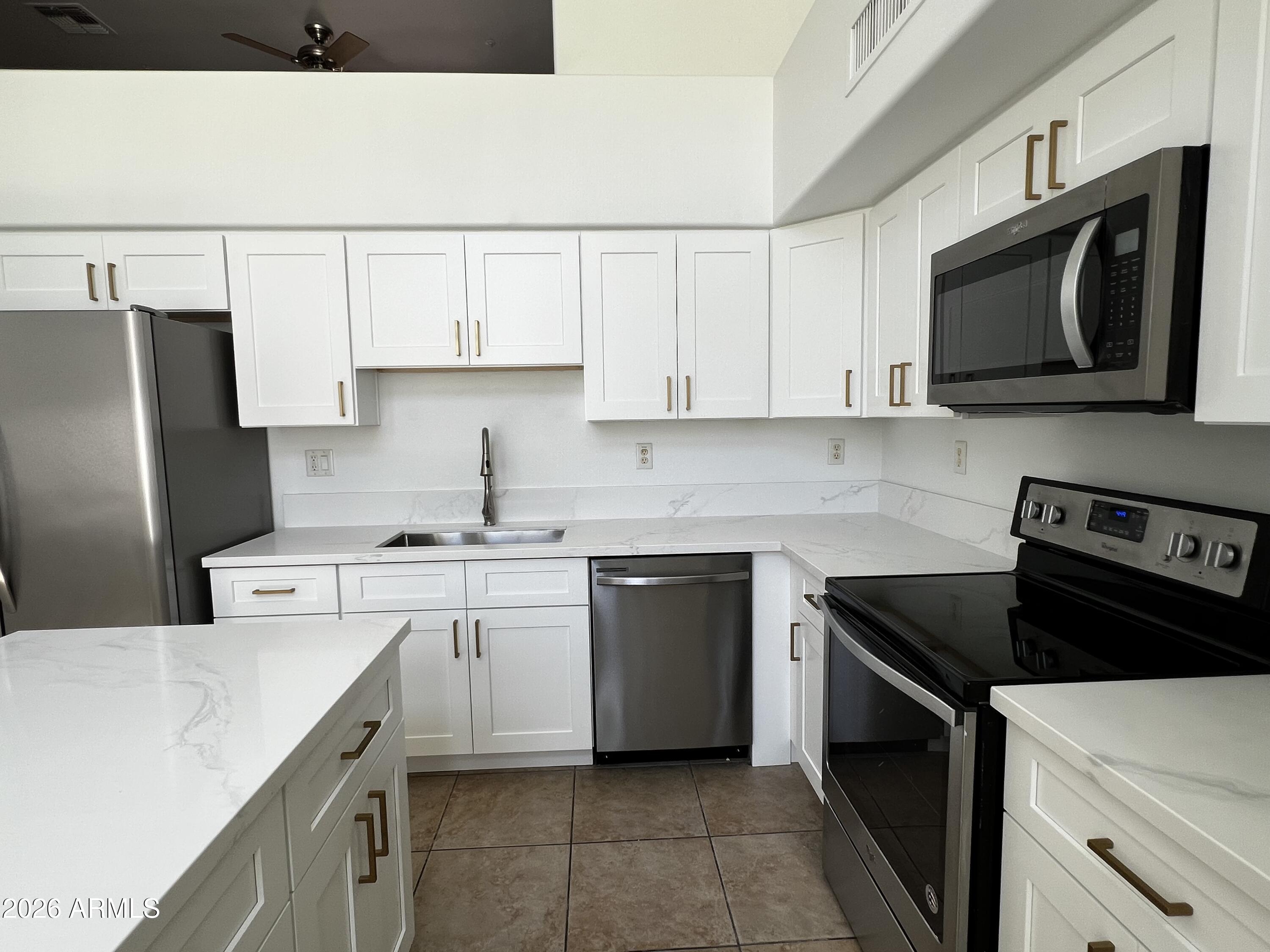 730 South Beck Avenue Tempe, AZ 85281 - Photo 9 of 29 a kitchen with stainless steel appliances a stove microwave and sink