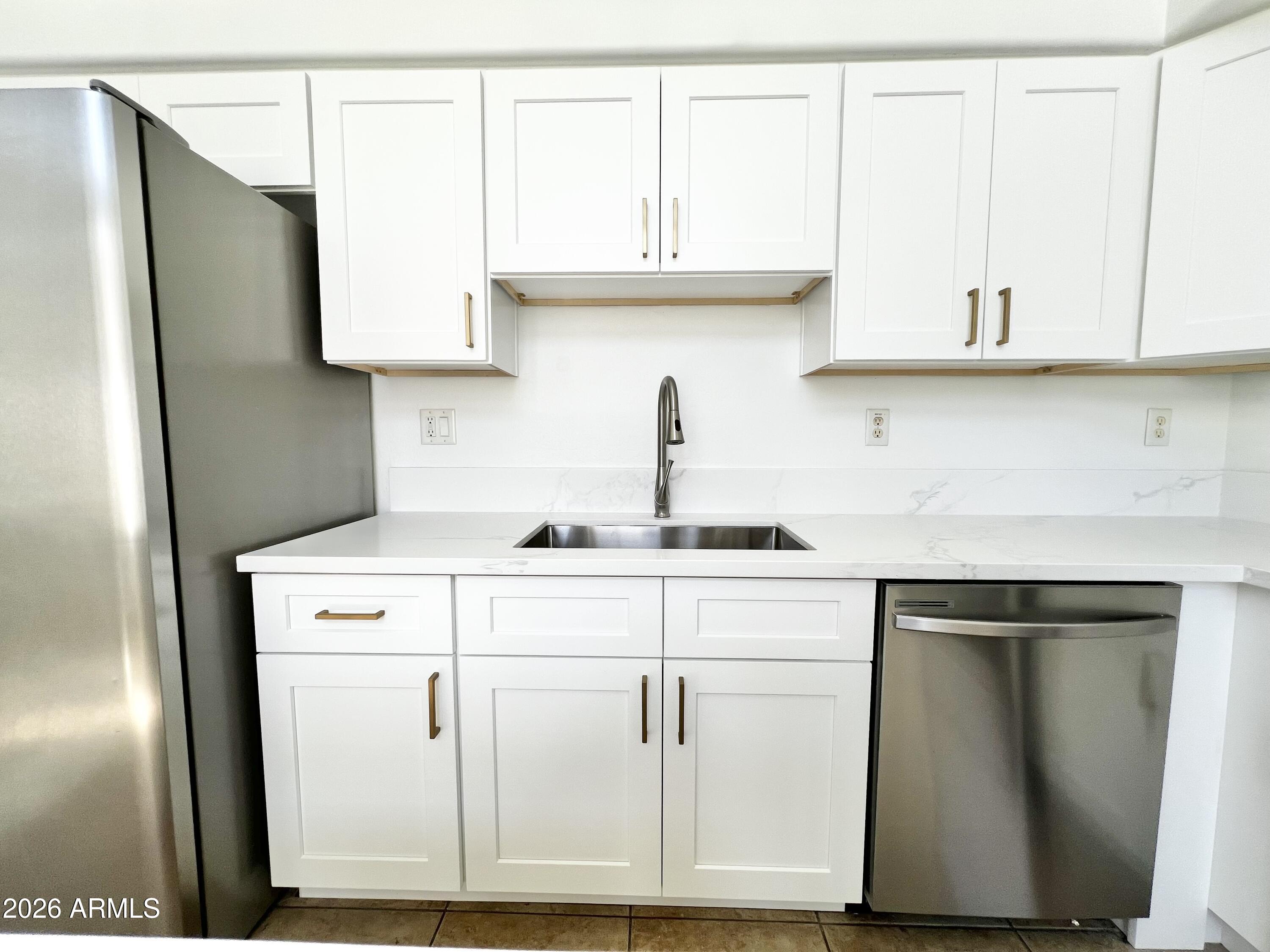 730 South Beck Avenue Tempe, AZ 85281 - Photo 10 of 29 a kitchen with cabinets and a stainless steel refrigerator stove
