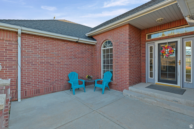 4117 North Wolf Ridge Circle Eden, UT 84310 - Photo 55 of 63 Brick exterior with a dark shingle roof and white gutters
