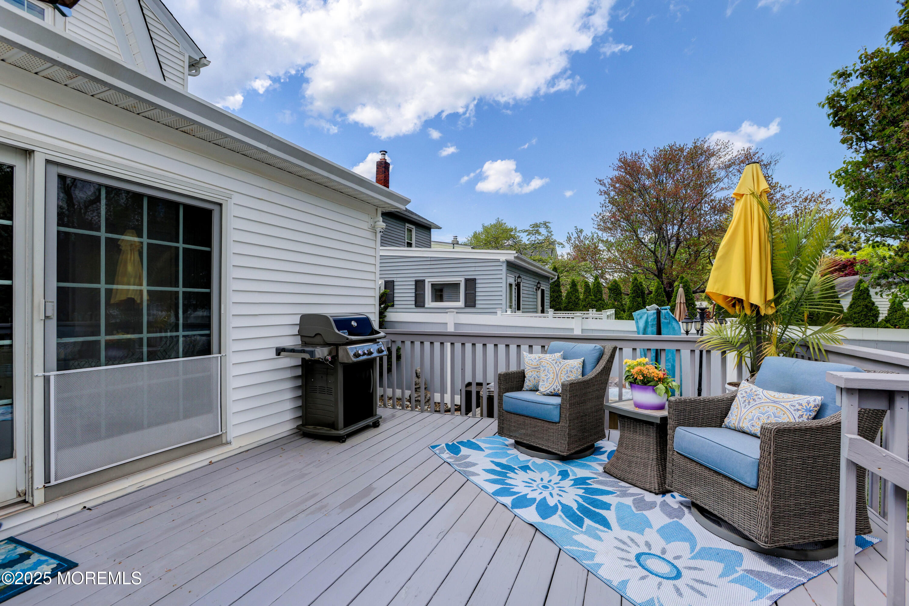 166 Grayson Avenue Hamilton, NJ 08619 - Photo 23 of 31 a view of a deck with couches table and chairs with wooden floor and fence