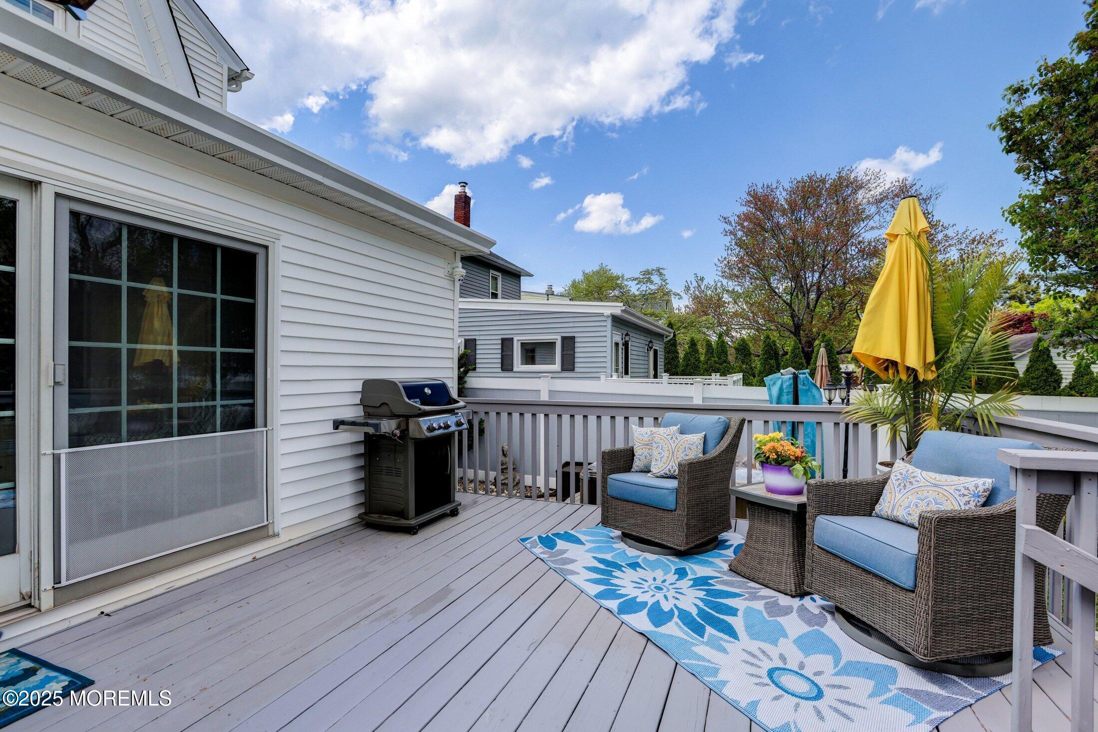166 Grayson Avenue Hamilton, NJ 08619 - Photo 24 of 31 a view of a deck with couches table and chairs with wooden floor and fence