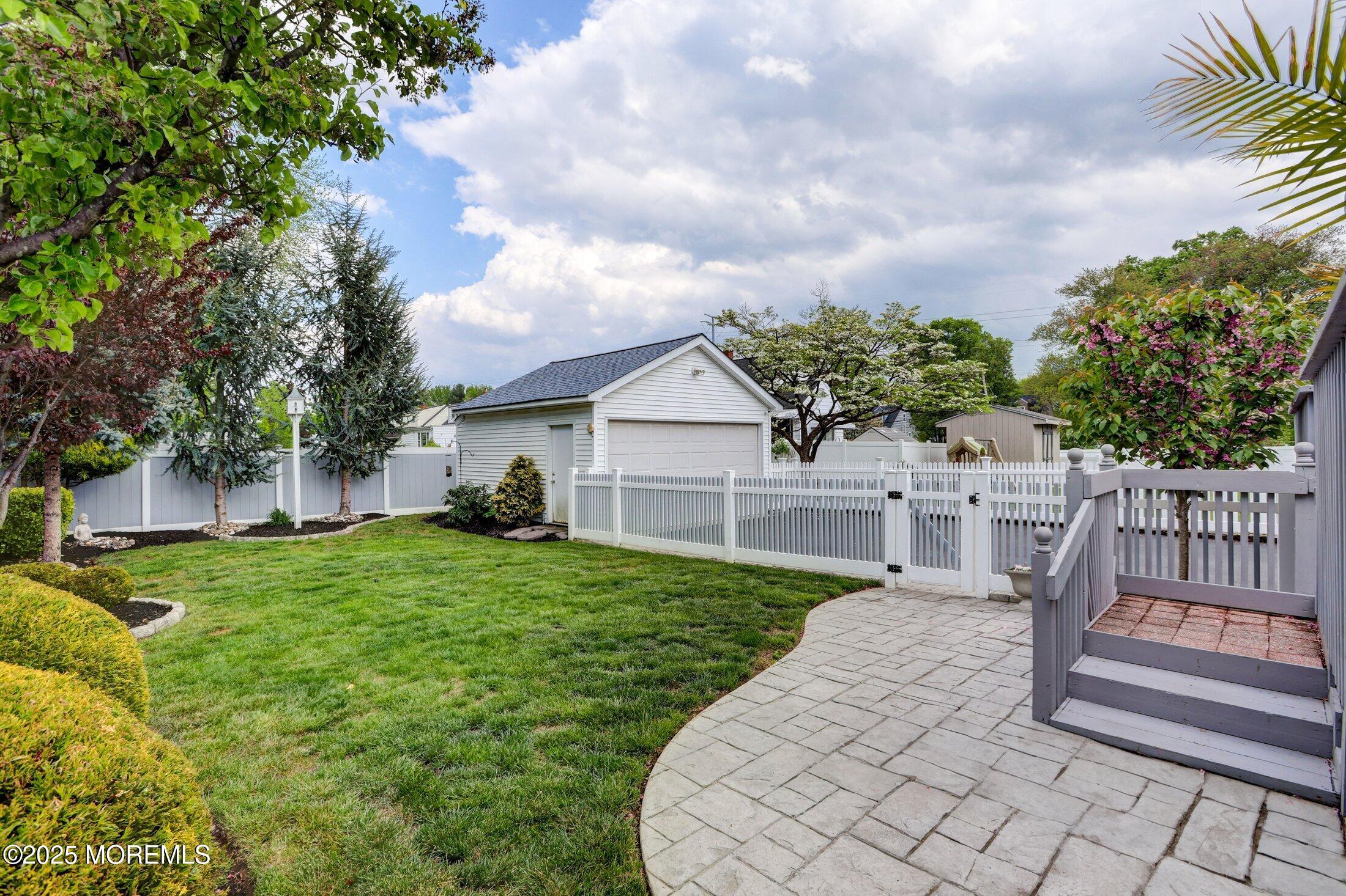 166 Grayson Avenue Hamilton, NJ 08619 - Photo 25 of 31 a view of a house with a small yard and wooden fence
