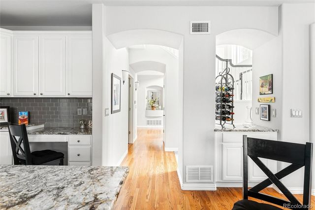 a kitchen with a wooden floor and a refrigerator