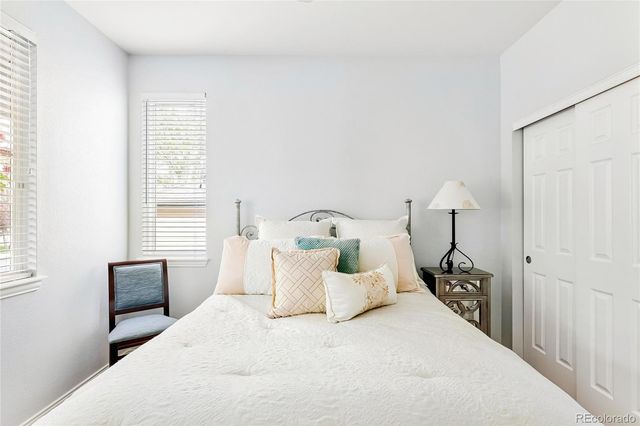 a bed room with a bed and a chair