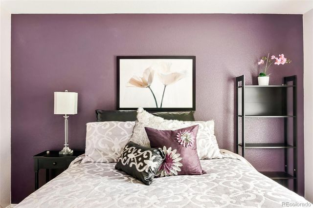 a bed room with a bed and a night stand