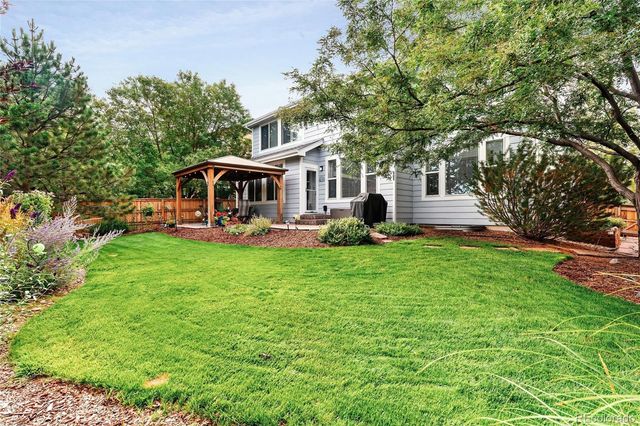 a front view of house with yard and outdoor seating