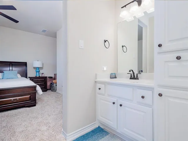 a en suite bathroom with a double vanity sink and a mirror