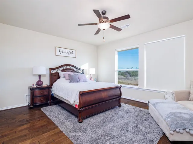 a bedroom with a large bed and a couch