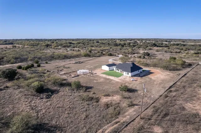 an aerial view of a houses with a yard